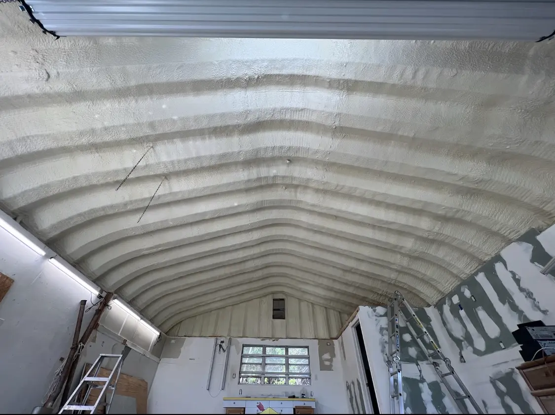 Spray polyurethane foam applied to the underside of a metal roof deck in Prairie View
